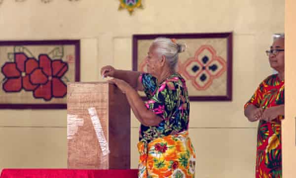 A woman places her vote into a ballot box on election day in Funafuti, the capital of the south Pacific nation of Tuvalu.