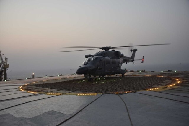 Indian_Navy_helicopter_on_the_helipad_of_an_ONGC_platform_off_the_coast_of_Mumbai_during_Exerc...jpg