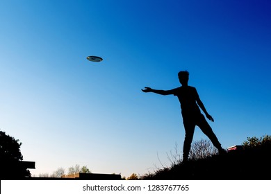 silhouette-boy-throwing-flying-disk-260nw-1283767765.jpg