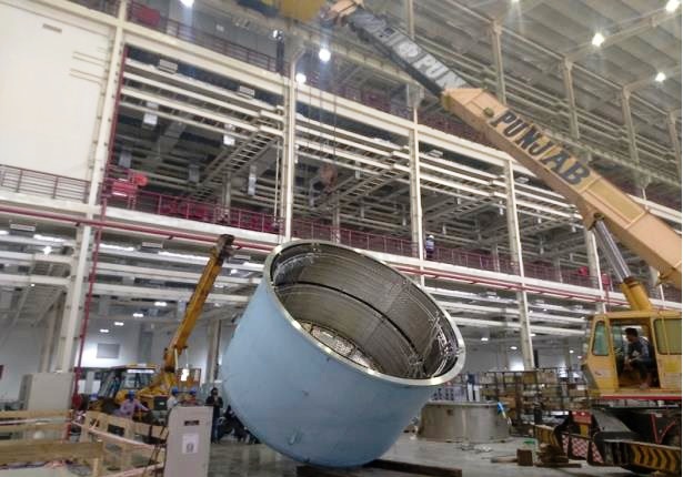 The upper portion of the cryostat being moved into position.jpg