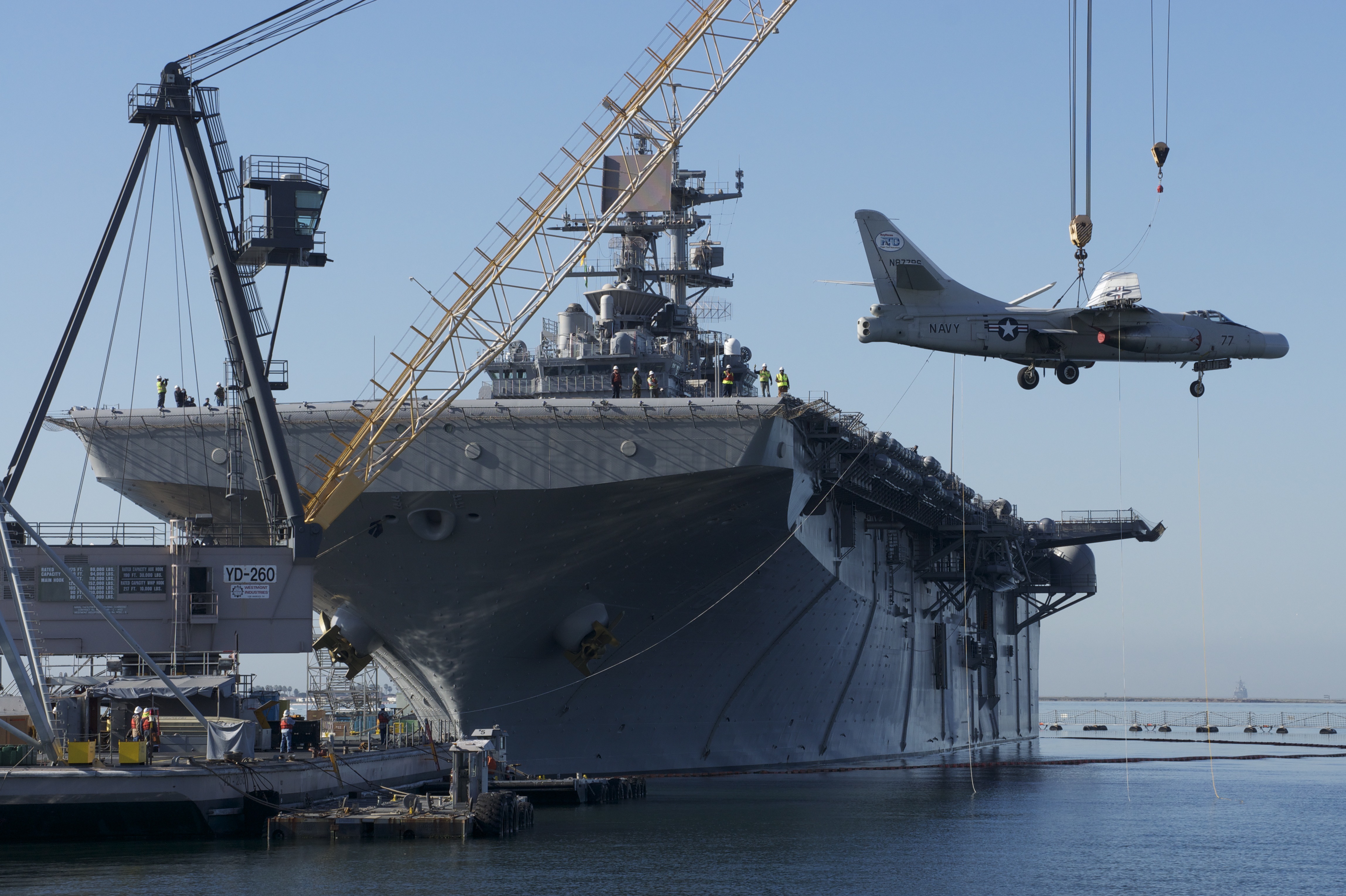 US_Navy_120208-N-ZC343-628_A_barge_crane_lifts_a_Navy_A3_to_the_flight_deck_of_the_amphibious_...jpg