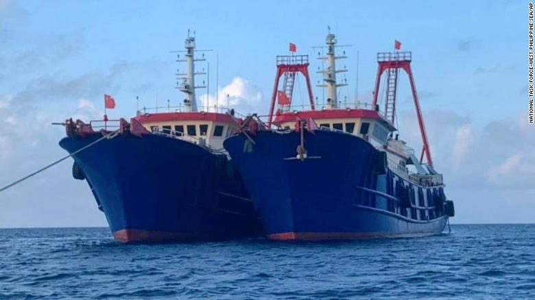 In this photo provided by the National Task Force-West Philippine Sea, Chinese vessels are moored at Whitsun Reef, South China Sea, on March 27, 2021. 