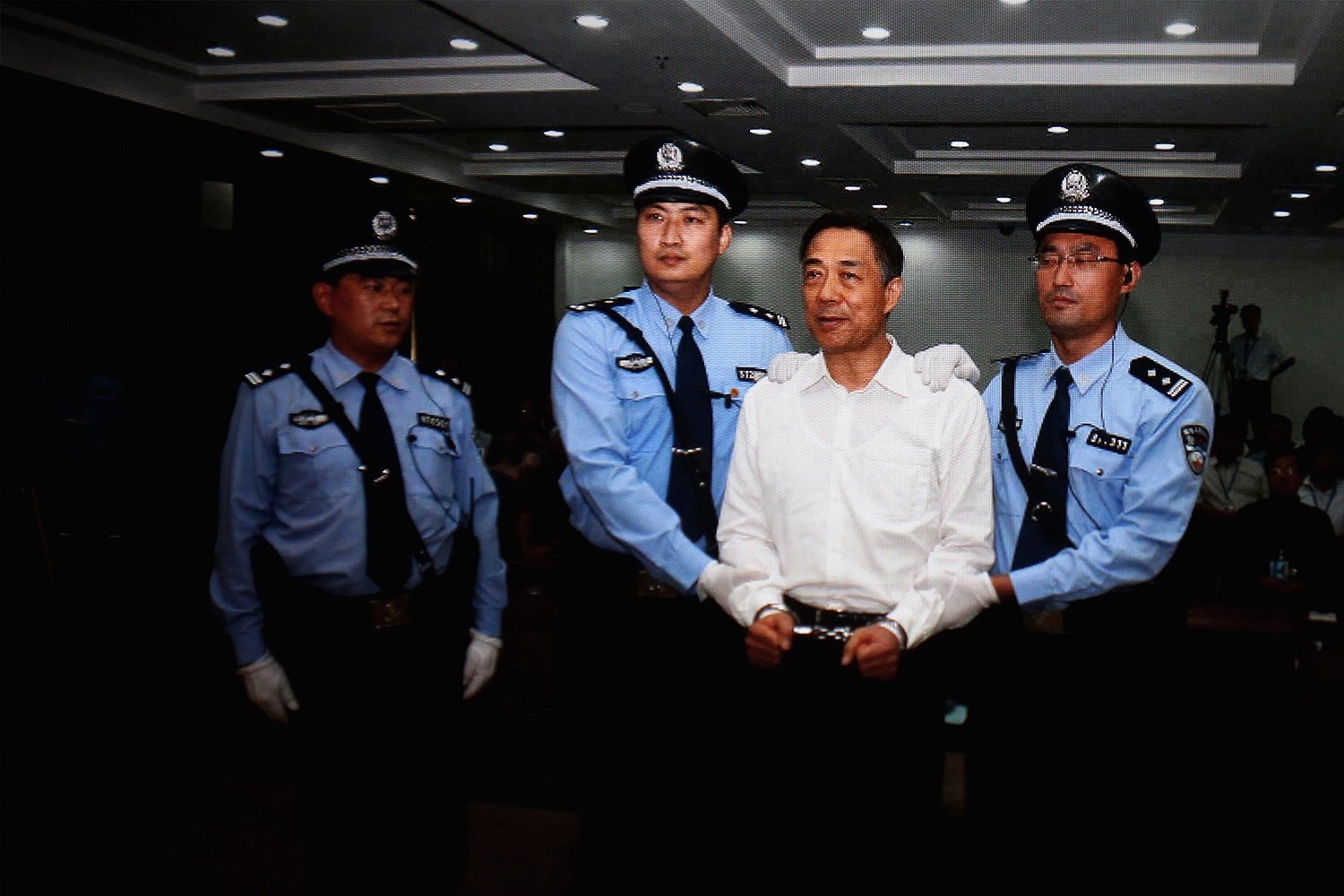 A screen shows the sentencing of Bo Xilai in Beijing on Sept. 2, 2013. The former Chinese politician was sentenced to life imprisonment for bribery, embezzlement, and abuse of power.