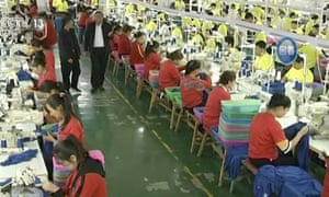 In this undated video footage run by China’s CCTV, Muslim trainees work in a garment factory at the Hotan Vocational Education and Training Center in Hotan, Xinjiang.