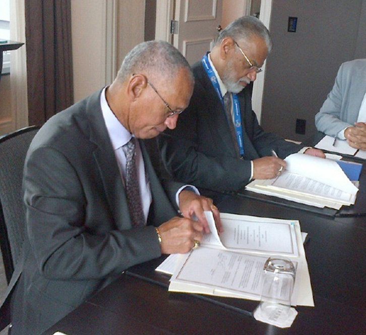 two men signing documents